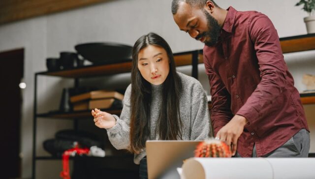 people looking at laptop