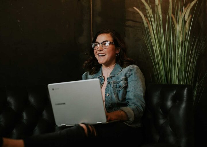 smiling woman using laptop