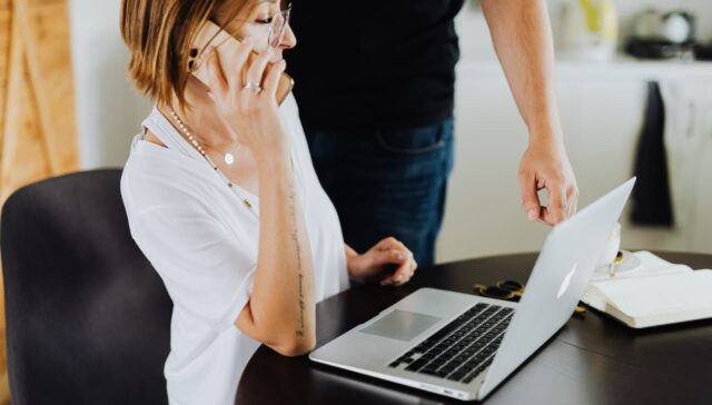 woman on the phone and using laptop