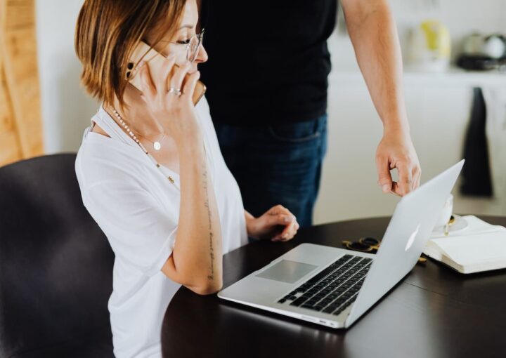 woman on the phone and using laptop