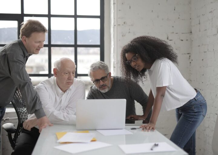 people looking at laptop