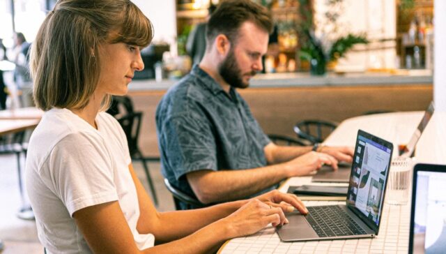 man and woman working designing website