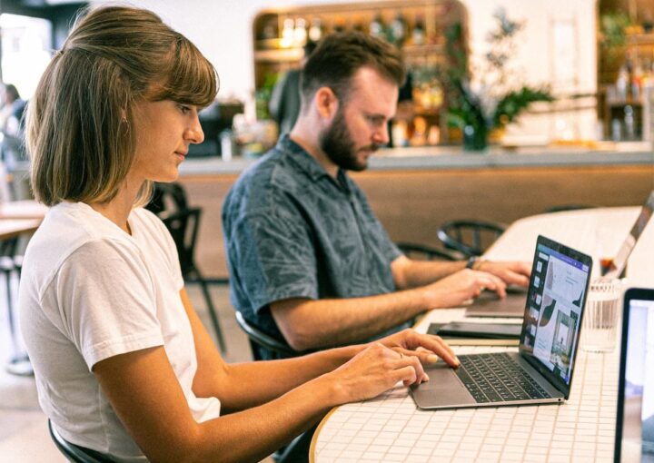 man and woman working designing website